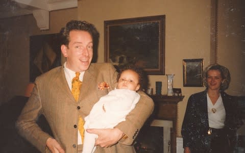 Aboah held by her godfather at her christening - Credit: Courtesy of Adwoa Aboah