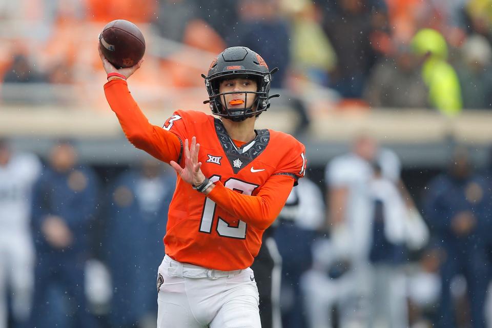 OSU quarterback Garret Rangel (13) throws a pass against West Virginia last season at Boone Pickens Stadium in Stillwater.