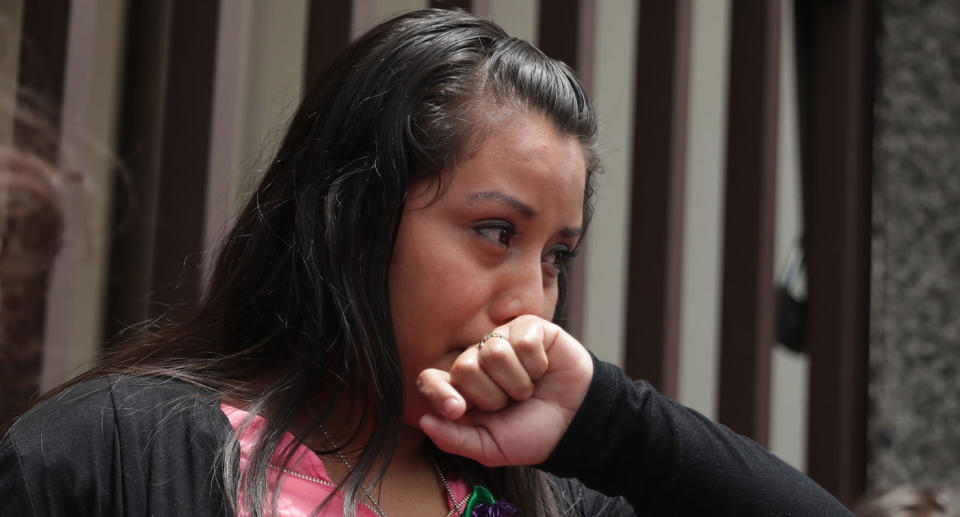 El Salvador woman shown crying after being acquitted of crimes relating to the stillbirth of her baby.