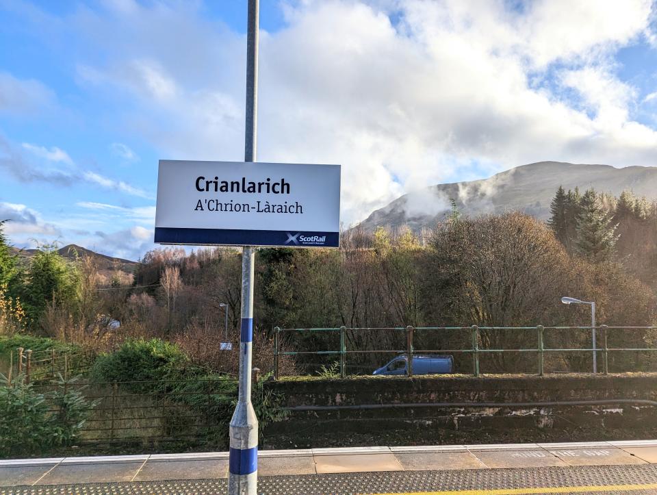 Crianlarich Junction station sign with mountains in the background