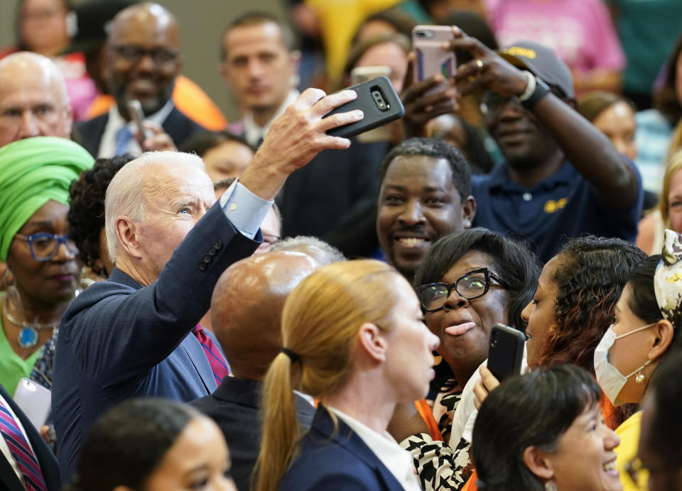 President Joe Biden takes a selfie with members of the audience after speaking during a visit to a mobile COVID-19 vaccination unit at the Green Road Community Center in Raleigh, N.C., Thursday, June 24, 2021. (AP Photo/Susan Walsh)