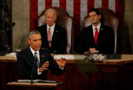 U.S. Vice President Joe Biden (L, rear) and Speaker of the House Paul Ryan (R, rear) look on as U.S. President Barack Obama delivers his State of the Union address to a joint session of Congress in Washington, January 12, 2016. REUTERS/Carlos Barria