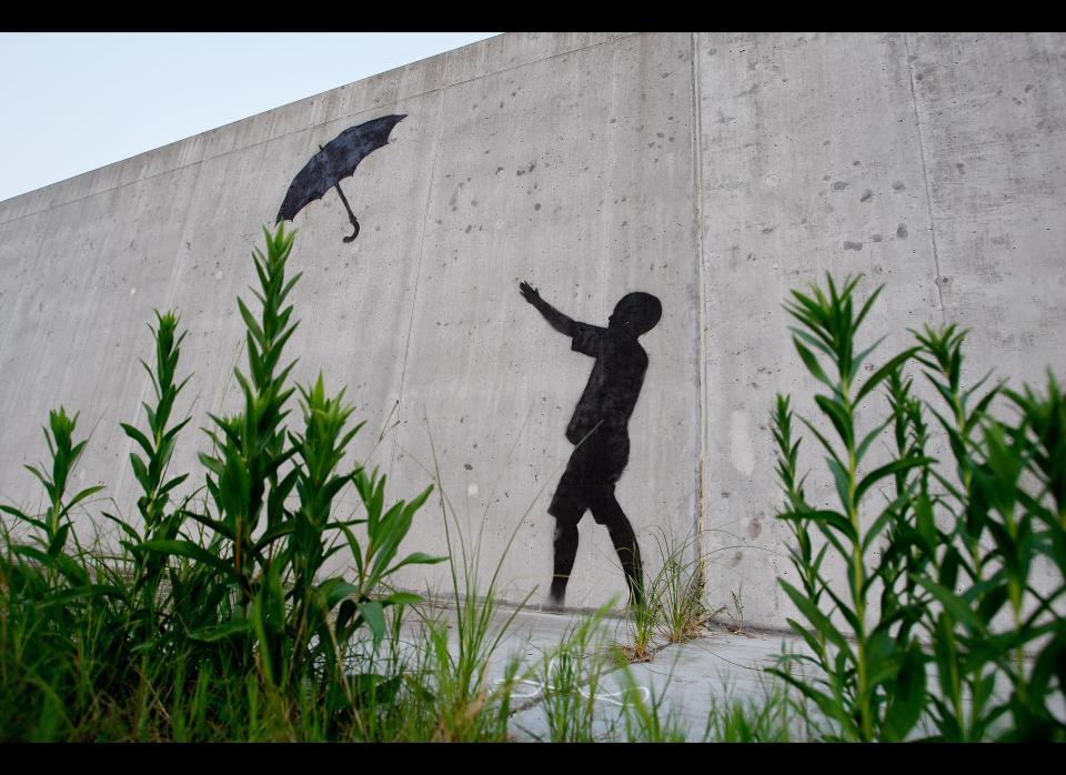 NEW ORLEANS - AUGUST 29:  Grafitti by the illusive artist Banksy adorns the levee wall in the Lower Ninth Ward on August 29, 2008 in New Orleans, Louisiana. New works by the artist, whose paintings are also sold in galleries, have been popping up throughout New Orleans coinciding with the third anniversary of Hurricane Katrina.  (Photo by Chris Graythen/Getty Images)