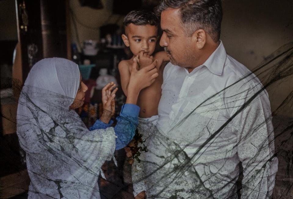 Zahra, 12, at home with her father and younger brother in Lahore (Nad É Ali/Save the Children)