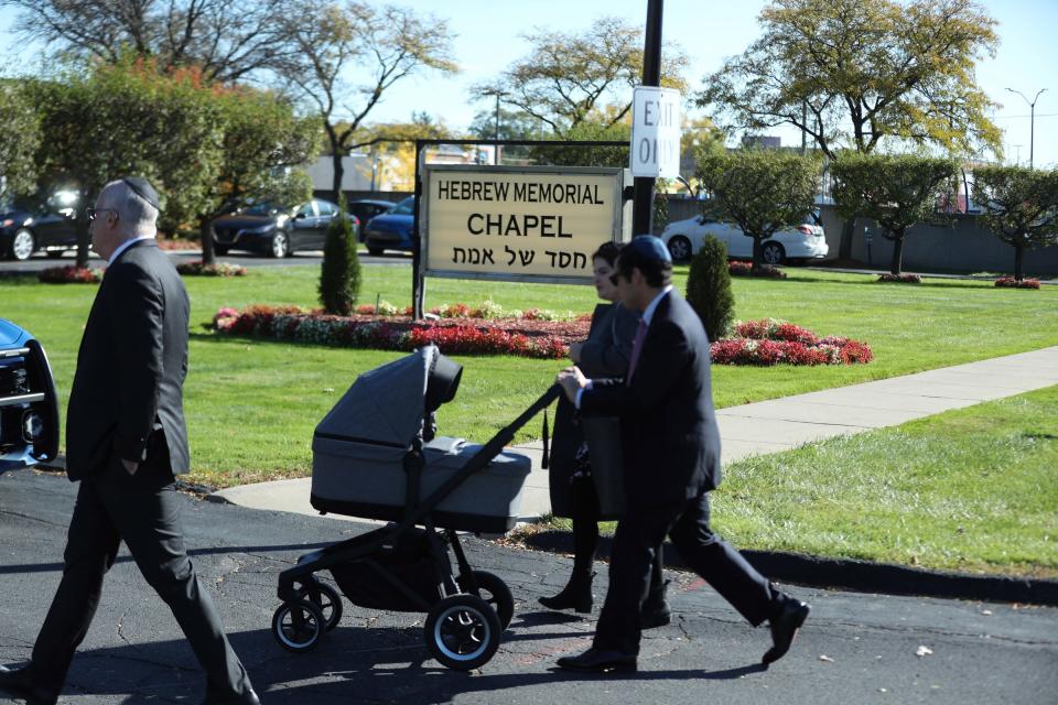 Friends and family arrive for the funeral services of Samantha Woll at the Hebrew Memorial Chapel on Sunday. Woll 40, was found stabbed to death near her Lafayette Park home Saturday.