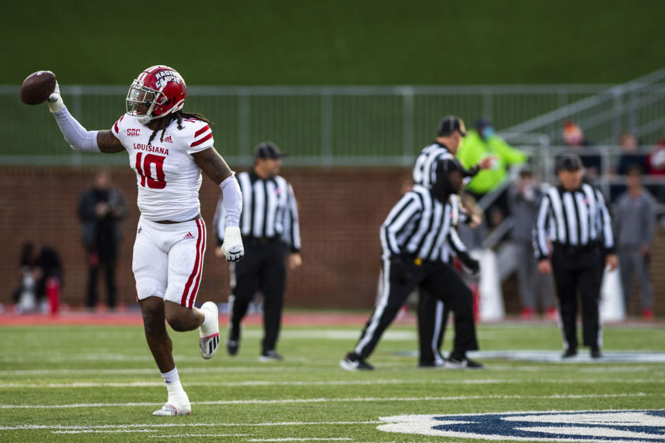 Louisiana-Lafayette defensive lineman Andre Jones (10) holds the ball up in celebration after recovering a fumble and causing a turnover against Liberty during an NCAA college football game, Saturday, Nov. 20, 2021, at Williams Stadium in Lynchburg, Va. (AP Photo/Kendall Warner)