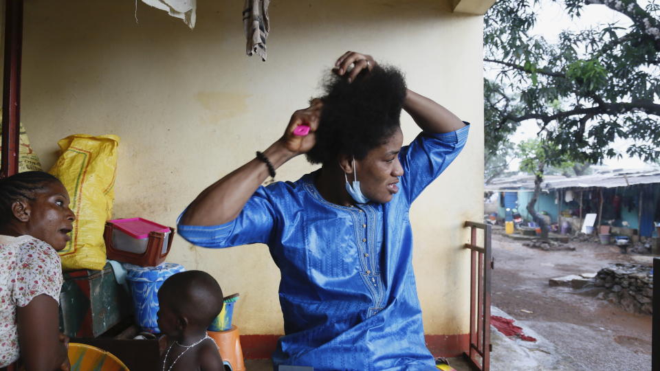 Guinean wrestler Fatoumata Yarie Camara combs her hair at her house in Conakry, Guinea, Wednesday July 21, 2021. A West African wrestler's dream of competing in the Olympics has come down to a plane ticket. Fatoumata Yarie Camara is the only Guinean athlete to qualify for these Games. She was ready for Tokyo, but confusion over travel reigned for weeks. The 25-year-old and her family can't afford it. Guinean officials promised a ticket, but at the last minute announced a withdrawal from the Olympics over COVID-19 concerns. Under international pressure, Guinea reversed its decision. (AP Photo/Youssouf Bah)