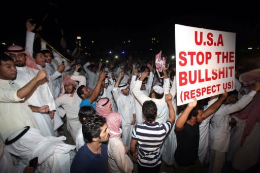 Kuwaitis protest near the US embassy in Kuwait City on September 13. The US boosted security at its embassies amid fears that more anti-American violence sparked by a film mocking Islam could erupt after Friday's Muslim prayers across the Middle East and North Africa