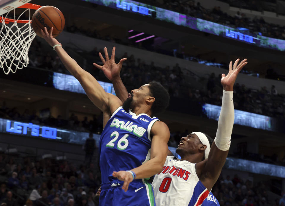 Dallas Mavericks guard Spencer Dinwiddie (26) goes up to shoot against Detroit Pistons center Jalen Duren (0) in the second half of an NBA basketball game Monday, Jan. 30, 2023, in Dallas. (AP Photo/Richard W. Rodriguez)