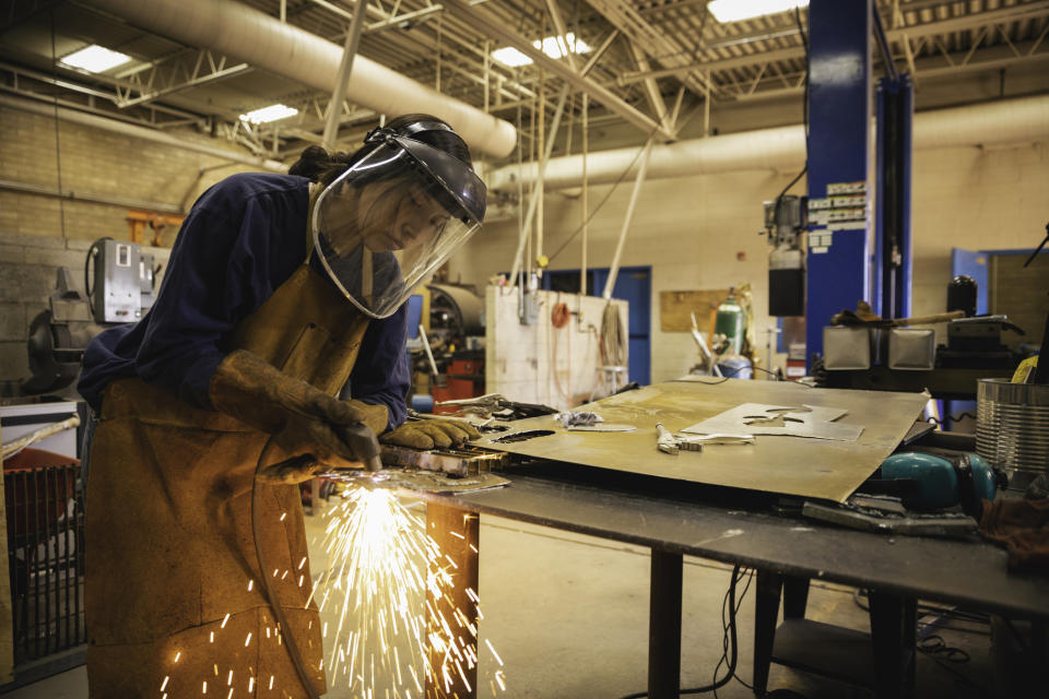 A woman is welding