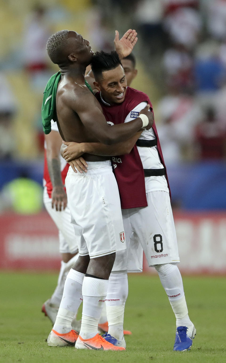 Peru's Luis Advincula, left, and teammate Christian Cueva celebrate their 3-1 victory over Bolivia in a Copa America Group A soccer match at Maracana stadium in Rio de Janeiro, Brazil, Tuesday, June 18, 2019. (AP Photo/Silvia Izquierdo)