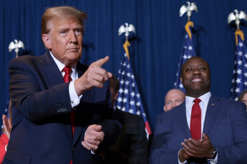 COLUMBIA, SOUTH CAROLINA - FEBRUARY 24: Republican presidential candidate and former President Donald Trump gestures to supporters as Sen. Tim Scott (R-SC) looks on during an election night watch party at the State Fairgrounds on February 24, 2024 in Columbia, South Carolina. Trump defeated Republican presidential candidate, former U.N. Ambassador Nikki Haley in her home state as South Carolina held its primary today. - Photo: Win McNamee (Getty Images)
