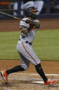 Baltimore Orioles shortstop Freddy Galvis (2) hits a home run during the third inning of a baseball game against the Miami Marlins, Tuesday, April 20, 2021, in Miami. (AP Photo/Marta Lavandier)