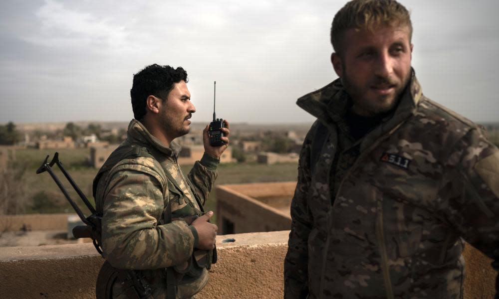 US-backed Syrian Democratic Forces fighters take up positions against Isis militants in Baghuz. 