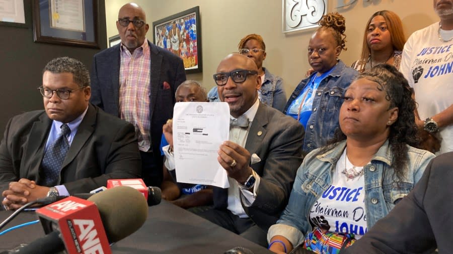 Lawyer Mawuli Davis holds up a document showing traffic charges dismissed against Johnny Hollman Sr. because he is dead in a news conference Tuesday in Decatur, Georgia. Atlanta Police Chief Darin Schierbaum on Tuesday fired the officer who electrically shocked Hollman during an Aug. 10 traffic stop, leading to Hollman’s death. (Photo: Jeff Amy/AP)