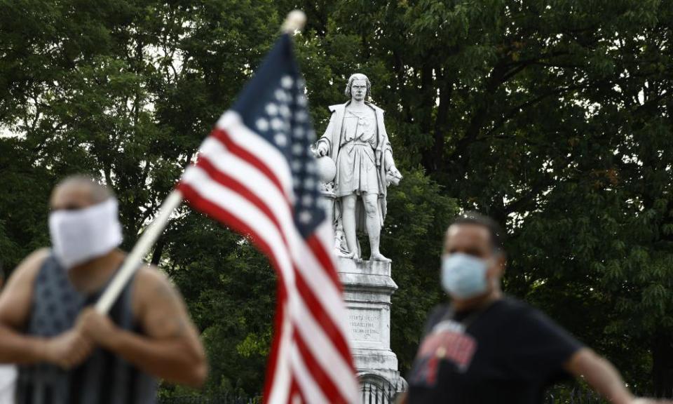 People gather near the statue of Christopher Columbus in South Philadelphia on 15 June 2020.