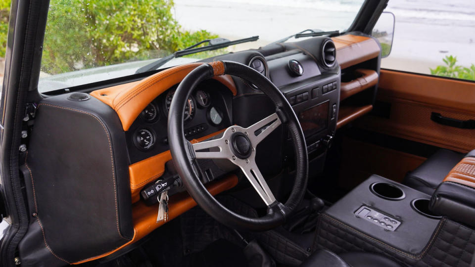 The steering wheel and dash of a Land Rover Defender 6x6 restomod from Manz Motor Company.
