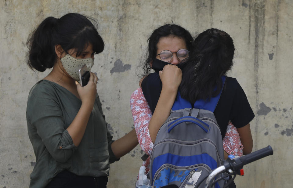 Relatives of a person who died of COVID-19 mourn at a crematorium in New Delhi, India, Friday, April 30, 2021. Indian scientists appealed to Prime Minister Narendra Modi to publicly release virus data that would allow them to save lives as coronavirus cases climbed again Friday, prompting the army to open its hospitals in a desperate bid to control a massive humanitarian crisis. (AP Photo)