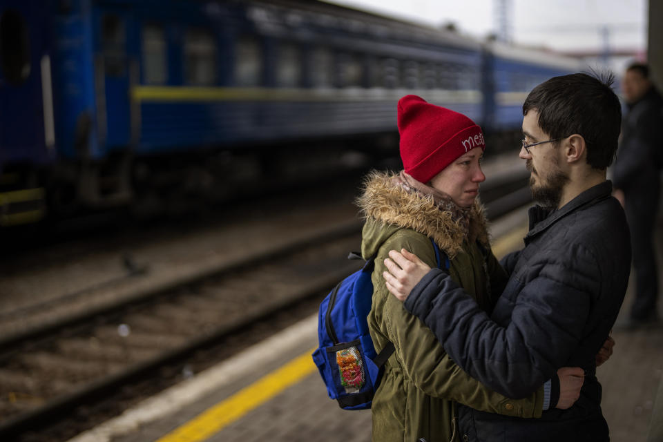 A couple say goodbye to each other at a train station in Kyiv on Thursday.