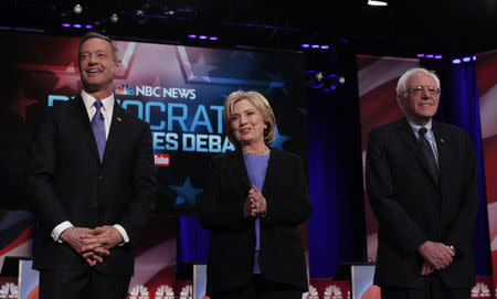 Martin O'Malley, Hillary Clinton and Bernie Sanders pose together before the start of the NBC News - YouTube Democratic presidential candidates debate January 17, 2016. REUTERS/Randall Hill