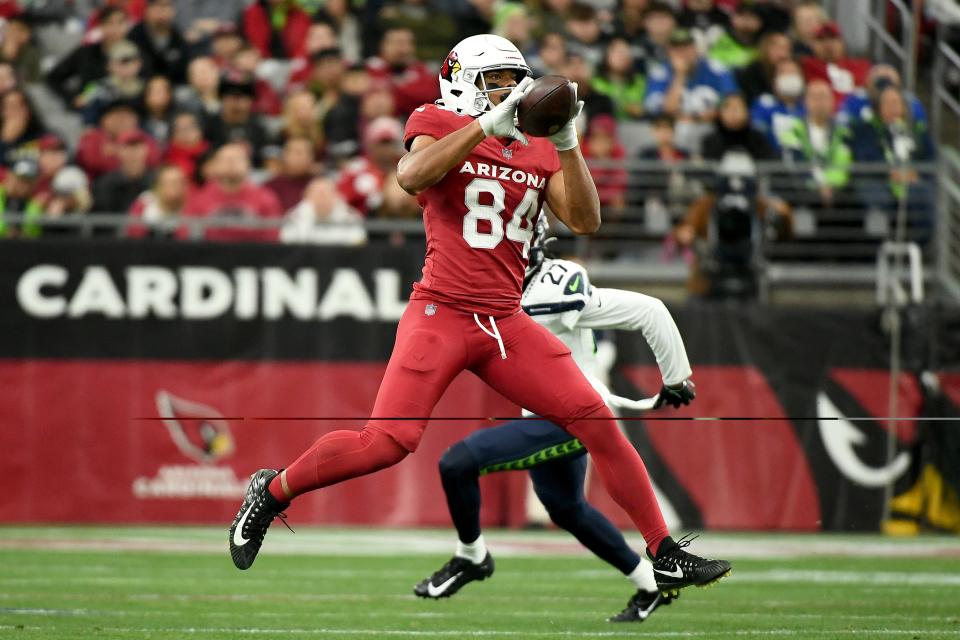 Elijah Higgins #84 of the Arizona Cardinals catches a pass against Riq Woolen #27 of the Seattle Seahawks during the third quarter at State Farm Stadium on Jan. 7, 2024, in Glendale.
