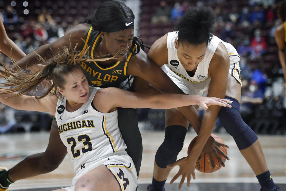 Michigan's Danielle Rauch (23) and Michigan's Jordan Hobbs (10) fight for control of the ball with Baylor's Queen Egbo (4) in the first half of an NCAA college basketball game, Sunday, Dec. 19, 2021, in Uncasville, Conn. (AP Photo/Jessica Hill)