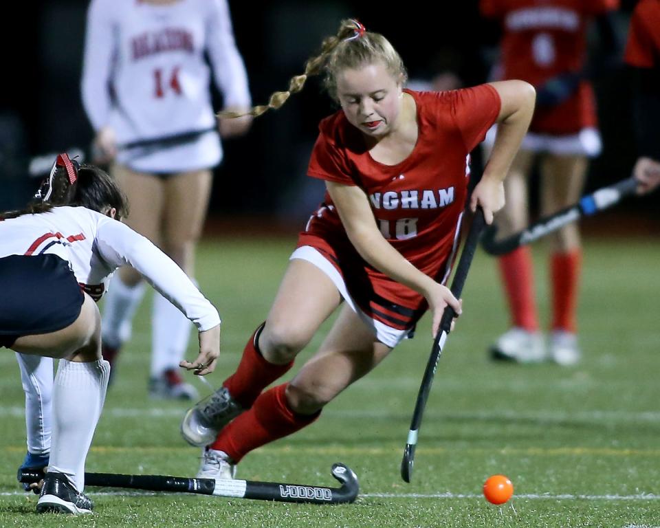 Hingham's Haylen Wilson looks to make a move around Reading’s Natalie Wall during second quarter action of their game against Reading in the Division 2 field hockey state semifinal game at Canton High School on Tuesday, November 14, 2023. Hingham would fall to Reading 5-0 ending Hingham's longest run in the tournament.