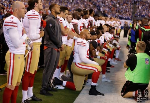 Members of the San Francisco 49ers kneel during the playing of the national anthem before an NFL football game against the Indianapolis Colts, Sunday, Oct. 8, 2017 - Credit: Michael Conroy/AP