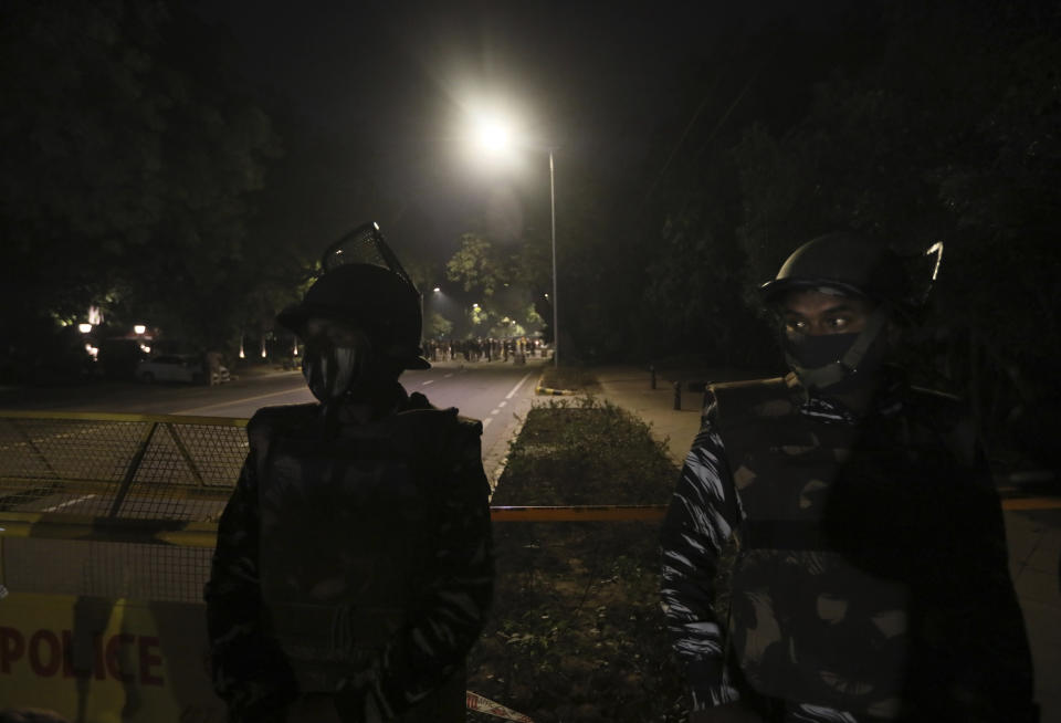 Policemen stand guard near the Israeli Embassy after a blast in the area in New Delhi, India, Friday, Jan. 29, 2021. A "very low intensity" device exploded Friday near the Israeli Embassy in the Indian capital, but there were no injuries and little damage, police said. (AP Photo/Manish Swarup)