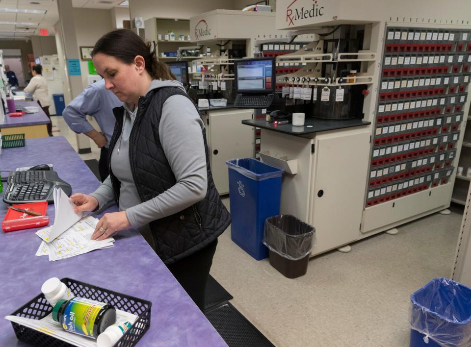 Pharmacy technician Megan Rasmussen works in the pharmacy in the Community Health Services clinic on the Oneida Indian Reservation in Oneida. The pharmacy, which fills about 1,000 prescriptions each day, is part of the clinic that receives about $20 million annually in federal funding.  Behind her are two automated dispensing systems for 450 of the most commonly prescribed medications.