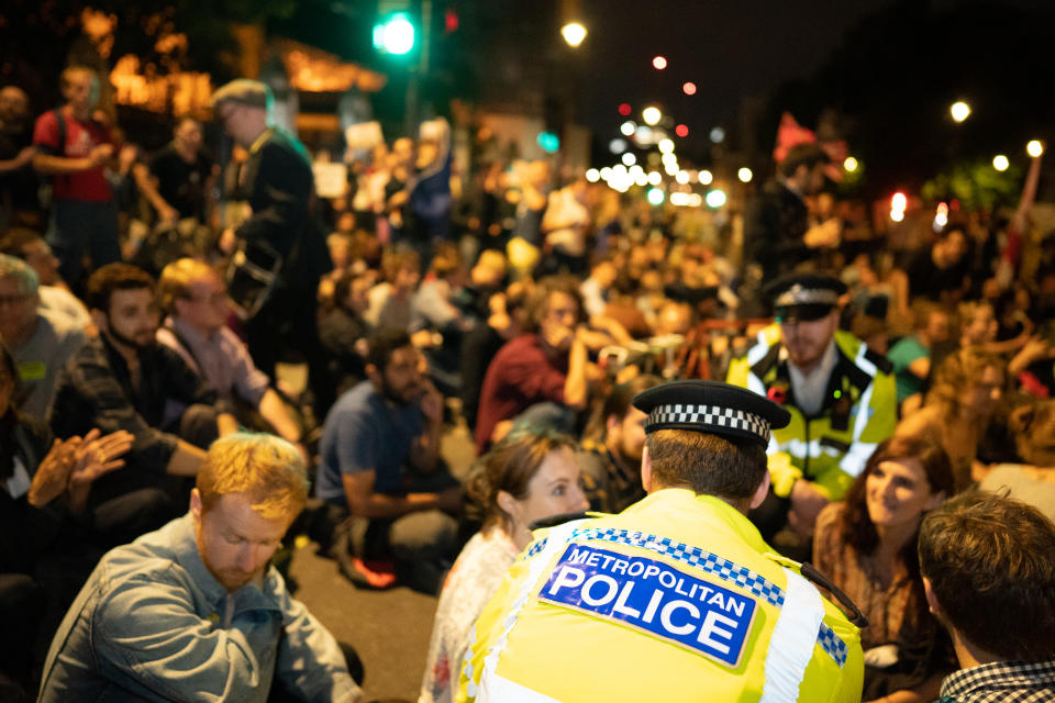 Police attempt to move protestors from the streets around Parliament Square