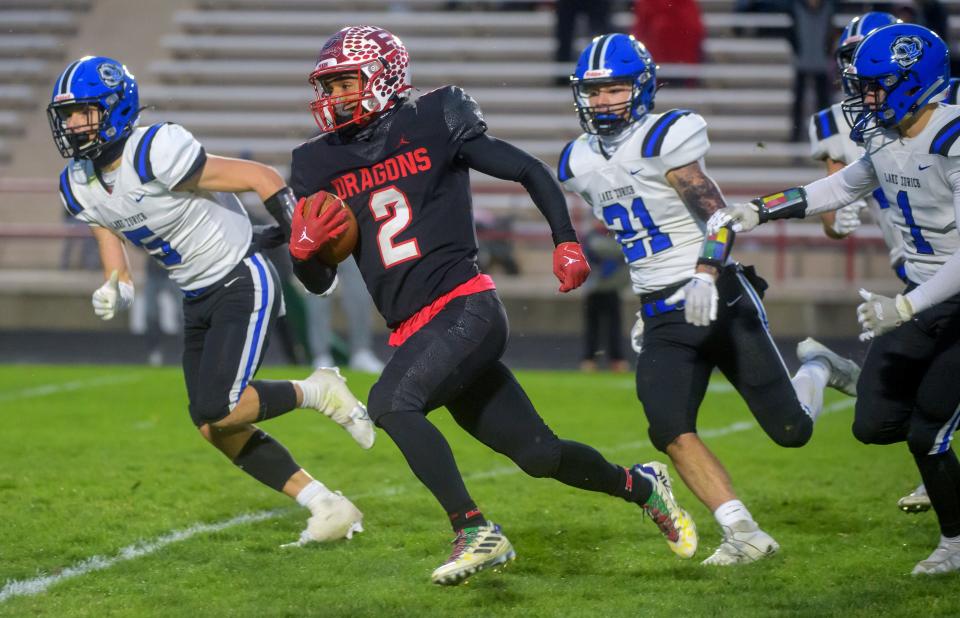 Pekin's Kanye Tyler runs a pass reception in for a touchdown against Lake Zurich in the closing seconds of their Class 7A football quarterfinal Saturday, Nov. 12, 2022 in Pekin.