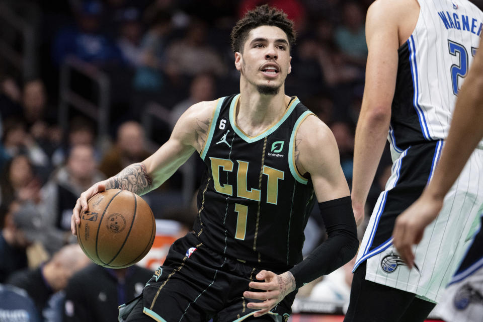 Charlotte Hornets guard LaMelo Ball (1) drives to the basket past Orlando Magic center Moritz Wagner during the first half of an NBA basketball game in Charlotte, N.C., Sunday, Feb. 5, 2023. (AP Photo/Jacob Kupferman)