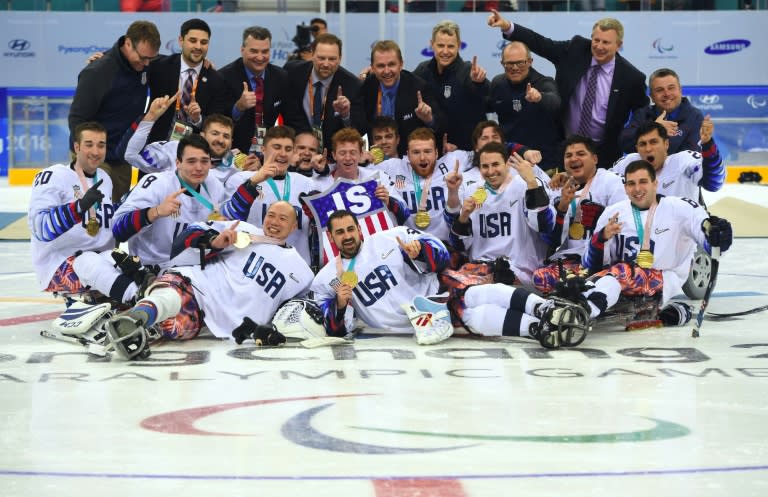 US players celebrate their victory in the ice hockey gold medal game