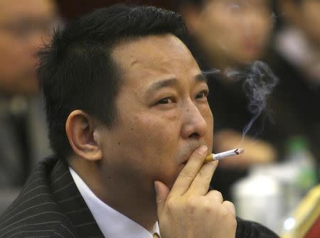 Liu Han, former chairman of Hanlong Mining, smokes a cigarette during a conference in Mianyang, Sichuan province, in this picture taken March 21, 2008. REUTERS/Stringer