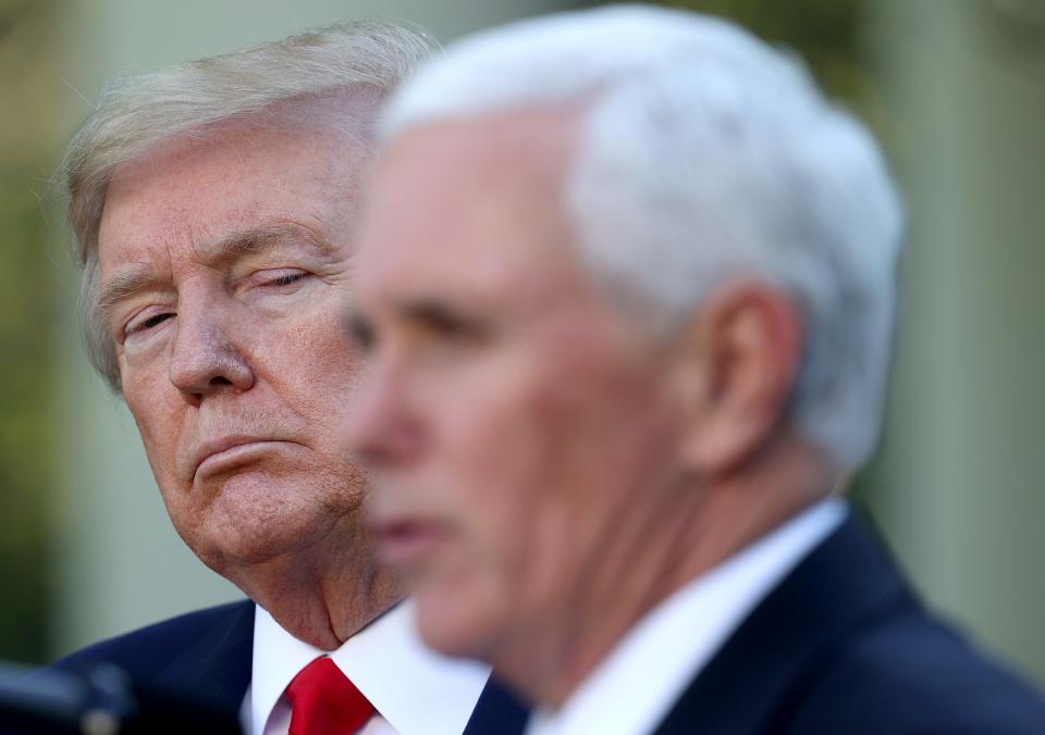 Donald Trump listens as Vice president Mike Pence answers questions during the daily briefing of the coronavirus task force in the Rose Garden of the White House on April 27, 2020 in Washington, DC. 