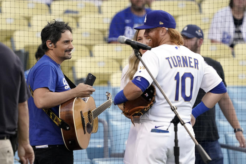 Country singer Brad Paisley, left, talks with Los Angeles Dodgers' Justin Turner prior to during a baseball game between the Dodgers and the Philadelphia Phillies Tuesday, June 15, 2021, in Los Angeles. Paisley sang the national anthem prior to the game. (AP Photo/Mark J. Terrill)