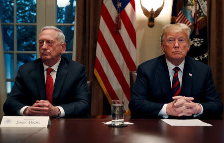 FILE PHOTO: U.S. President Donald Trump speaks to the news media while gathering for a briefing from his senior military leaders, including Defense Secretary James Mattis (L), in the Cabinet Room at the White House in Washington, U.S., October 23, 2018. REUTERS/Leah Millis/File Photo