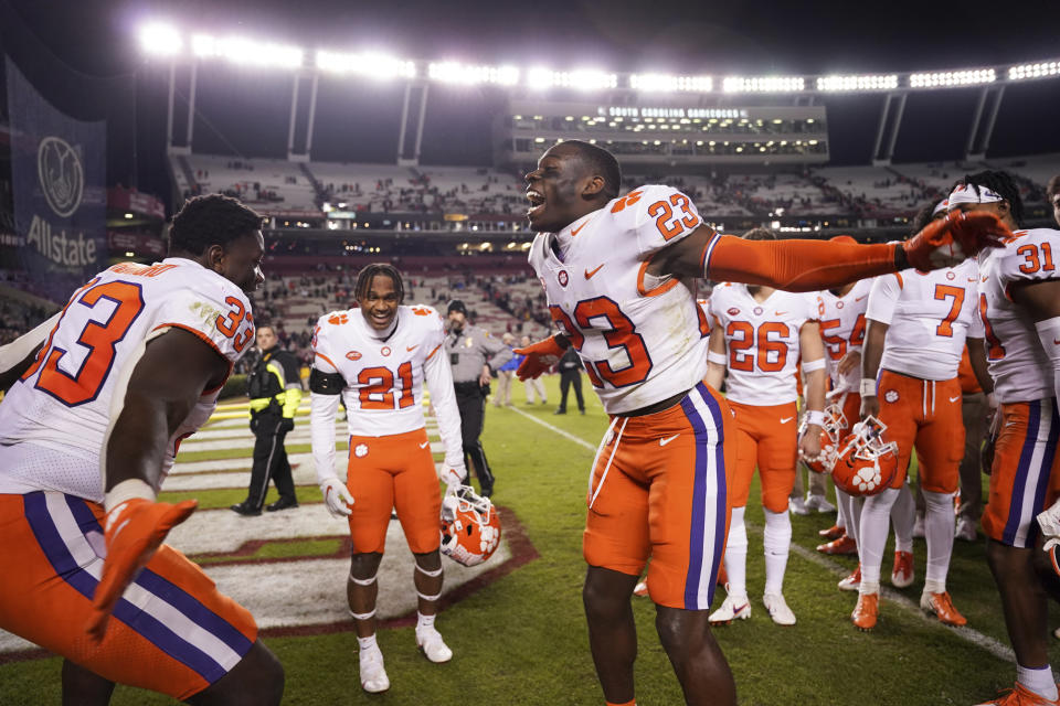 Clemson cornerback Andrew Booth Jr. (23) celebrates with defensive tackle Ruke Orhorhoro (33) after the team's NCAA college football game against South Carolina on Saturday, Nov. 27, 2021, in Columbia, S.C. Clemson won 30-0. (AP Photo/Sean Rayford)