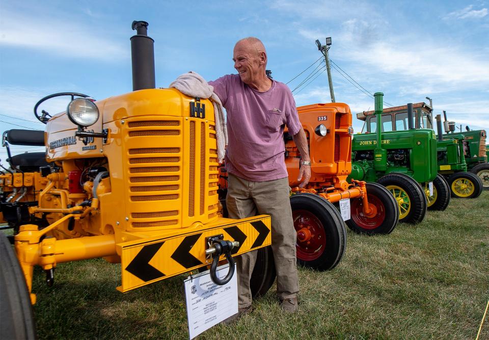 Wiping the dirt off of one of his tractor entries is Frank Bergmaier, of Langhorne, during the preparations for the upcoming Middletown Grange Fair in Wrightstown, on Monday, Aug. 15, 2022.
