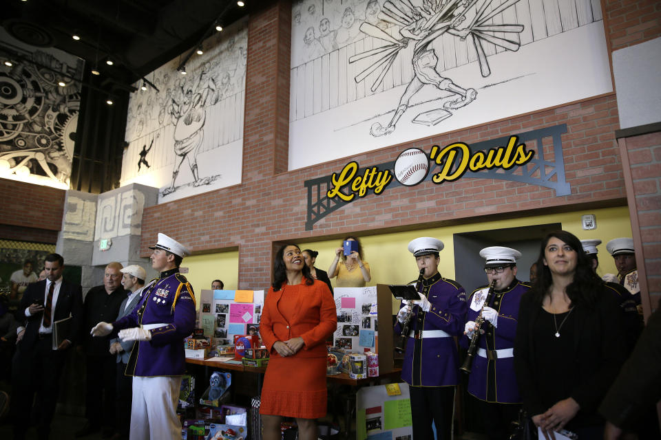 San Francisco Mayor London Breed looks up at the numerous murals on the walls during the opening of Lefty O'Doul's new 20,000 square foot Baseball Ballpark Buffet & Café at Fisherman's Wharf. Tuesday, Nov. 20, 2018, in San Francisco. The popular Union Square bar and restaurant Lefty O'Doul's closed in January 2017 due to a dispute between the owner and his landlord, but now the restaurant has returned on the wharf. Lefty O'Doul's was named after the well-known and respected New York Giants star outfielder. With a .398 batting average, he boasted the highest average out of any outfielder in the 20th century. (AP Photo/Eric Risberg)