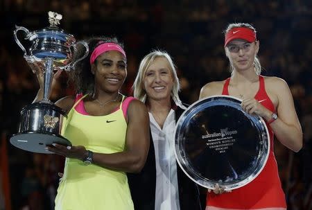 Tennis great Martina Navratilova (C) stands with Serena Williams (L) of the U.S. as she holds the winner's trophy next to Maria Sharapova of Russia after winning their women's singles final match at the Australian Open 2015 tennis tournament in Melbourne January 31, 2015. REUTERS/Issei Kato