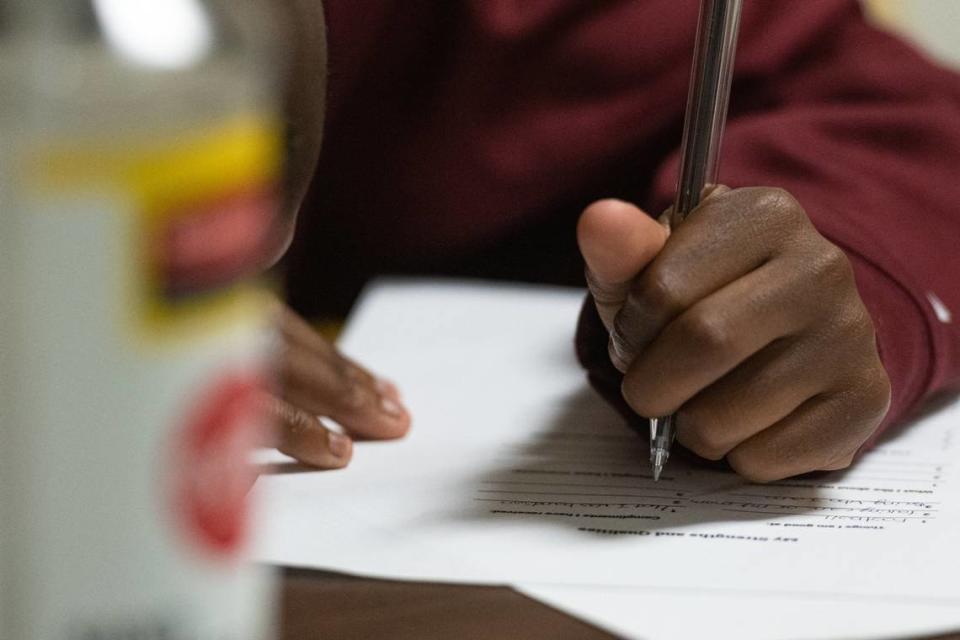 A young participant completes an exercise given to them by Lisa Hollis during an evening session in the Juvenile Court Intervention Program through the Mecklenburg Council of Elders Wednesday, Aug. 3, 2022 in the former Plaza Road Pre-K building in Charlotte, N.C.