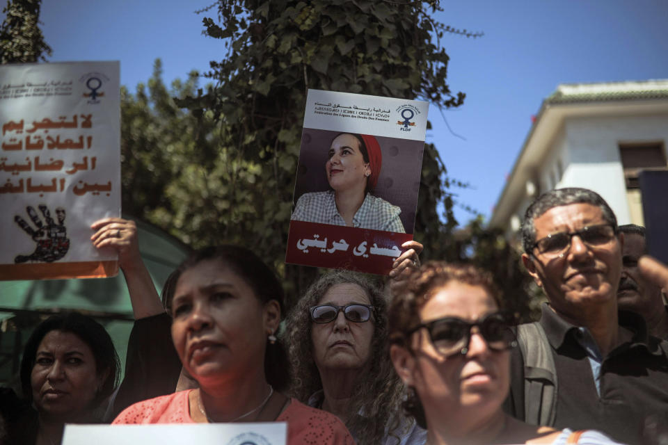 People stage a demonstration outside a court in solidarity with detained journalist Hajar Raissouni, in Rabat, Morocco, Monday, Sept. 9, 2019. Banners in Arabic read "Free Hajar" and "No to criminalizing consensual relationships". (AP Photo/Mosa'ab Elshamy)