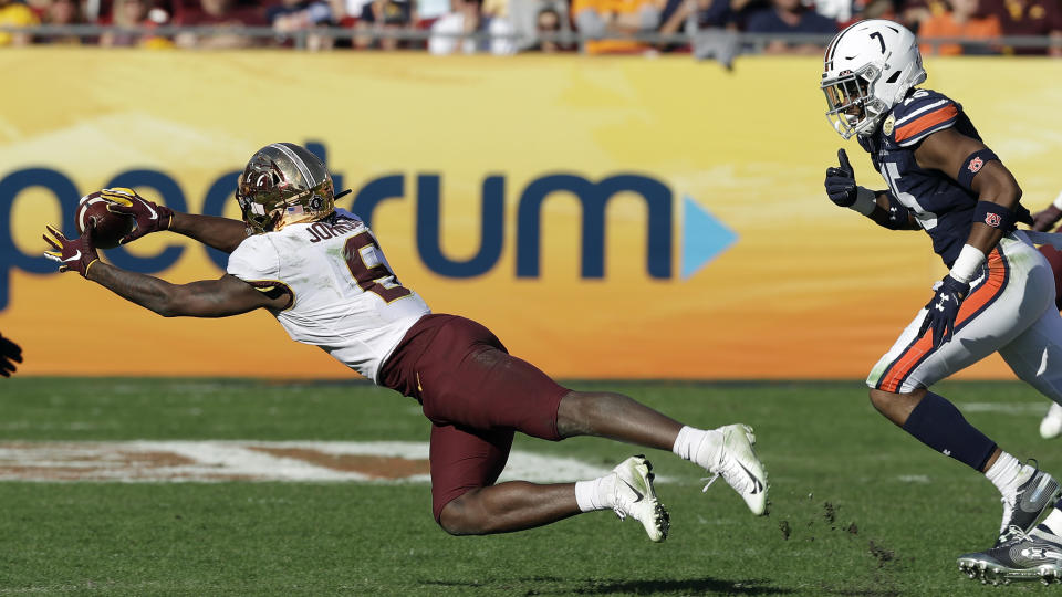 Minnesota wide receiver Tyler Johnson (6) makes a diving catch in front of Auburn defensive back Jordyn Peters (15) during the second half of the Outback Bowl NCAA college football game Wednesday, Jan. 1, 2020, in Tampa, Fla. (AP Photo/Chris O'Meara)