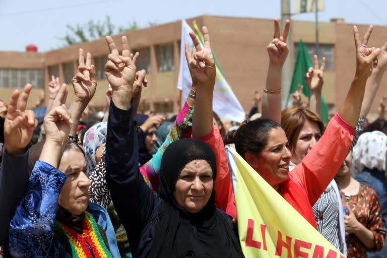 Men and women marched through the Kurdish-controlled city of Qamishli on Saturday to protest Turkey's military presence in Syria