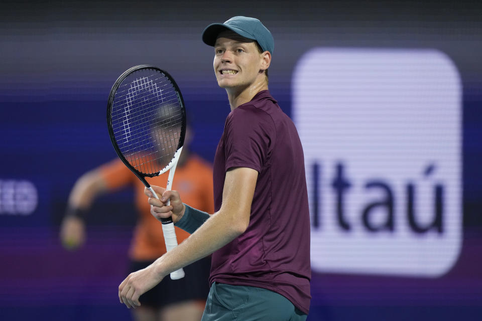 Jannik Sinner, of Italy, smiles after winning a point against Carlos Alcaraz, of Spain, during the Miami Open tennis tournament, Friday, March 31, 2023, in Miami Gardens, Fla. (AP Photo/Wilfredo Lee)