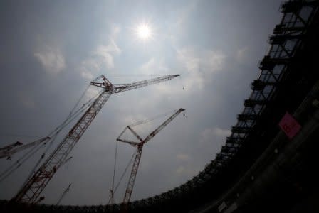 Construction site of the New National Stadium, the main stadium of Tokyo 2020 Olympics and Paralympics, is seen under the light of the sun during a heat wave in Tokyo, Japan July 18, 2018.  REUTERS/Issei Kato