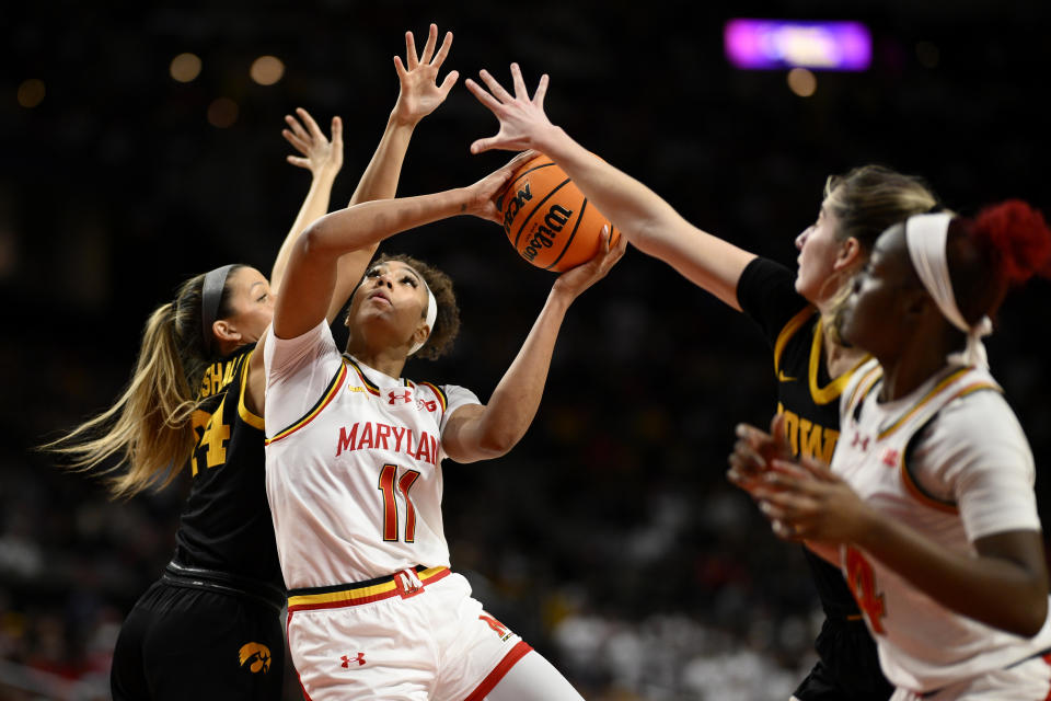 Maryland guard Jakia Brown-Turner (11) goes to the basket against Iowa guard Gabbie Marshall, left, during the second half of an NCAA college basketball game, Saturday, Feb. 3, 2024, in College Park, Md. (AP Photo/Nick Wass)