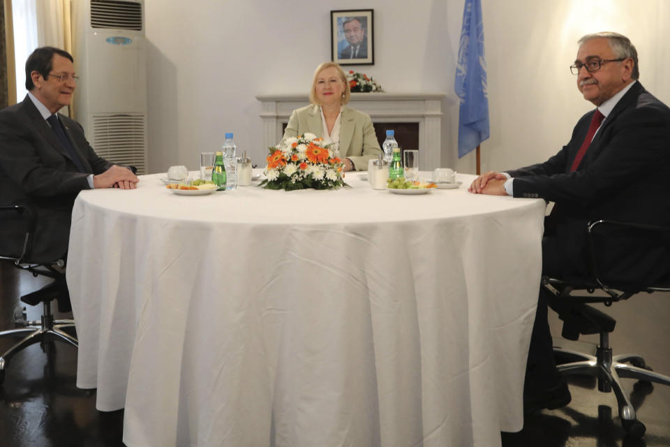 In this photo released from Cyprus' Press and Informations Office, Cyprus President Nicos Anastasiades, left, UN Secretary General's Special Representative to Cyprus Elizabeth Spehar, center, and Turkish Cypriot leader Mustafa Akinci are seen during their meeting inside the UN buffer zone in divided capital Nicosia, Cyprus, Friday, Aug. 9, 2019. The rival leaders of ethnically divided Cyprus are meeting to scope out whether there's enough common ground for a return to formal peace talks. (Stavros Ioannides/PIO via AP)